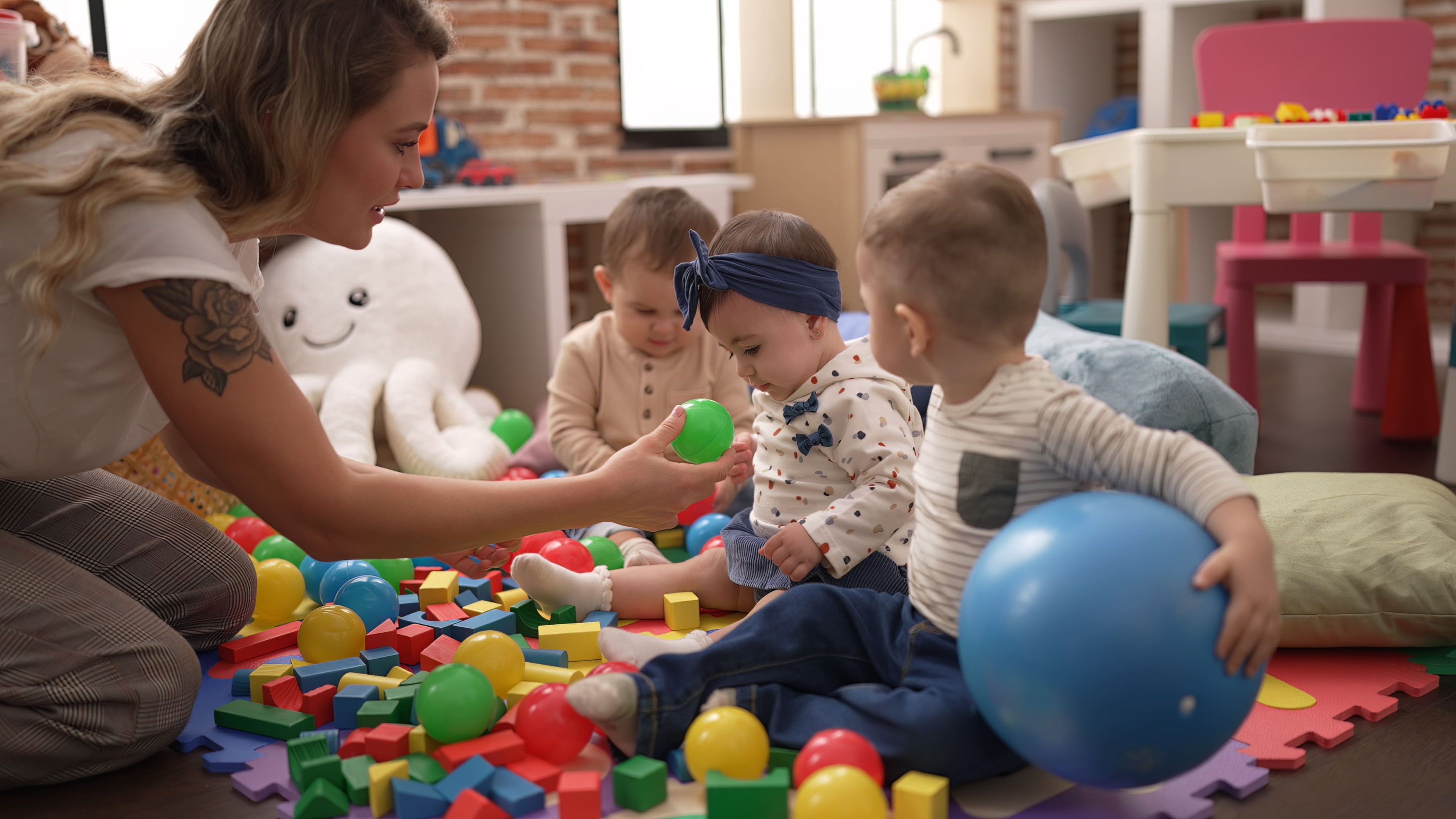 teacher-preschool-students-playing-with-balls-sitting-floor-kindergarten (1).jpg